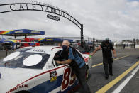 The car for driver Landon Cassill is pushed out of the garage area before the NASCAR Xfinity series auto race Tuesday, May 19, 2020, in Darlington, S.C. (AP Photo/Brynn Anderson)