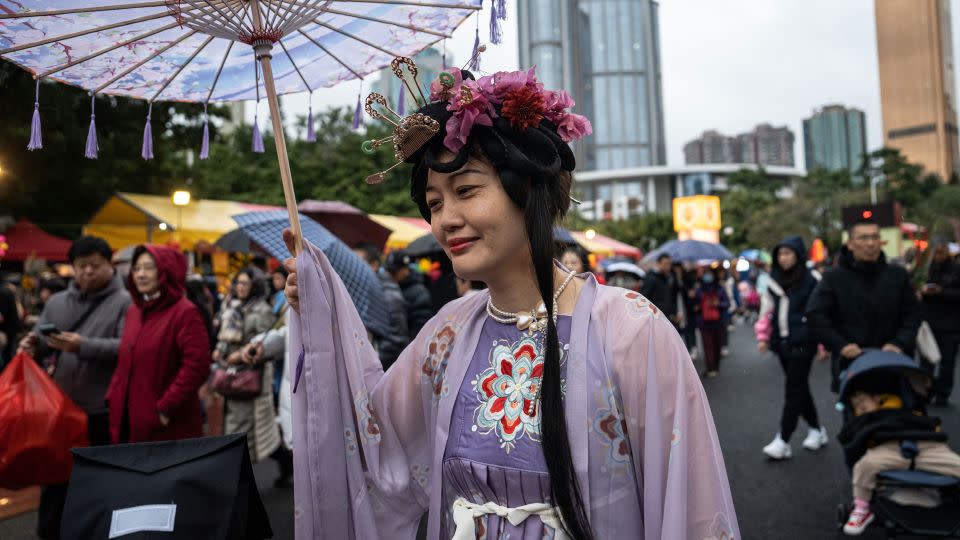 A woman wearing Hanfu strolls around the Spring Festival Flower Market in Guangzhou, China, on February 9, 2024. - John Ricky/Anadolu/Getty Images