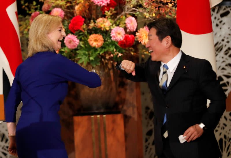 Britain's International Trade Secretary Elizabeth Truss and Japanese Foreign Minister Toshimitsu Motegi sign the UK-Japan Comprehensive Economic Partnership Agreement in Tokyo