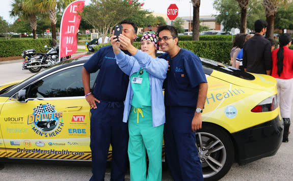 Doctors pause for a selfie with a nurse during the 2014 Drive for Men's Health. For this year's drive, Dr. Jamin Brahmbhatt and Dr. Sijo Parekattil, co-directors of the PUR Clinic in Clermont, Fl., will drive an all-electric Tesla more than 6,0