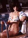 <p>Actress Joan Collins wears a floral bikini as she enjoys the pool in the backyard of her Beverly Hills home in 1976. </p>