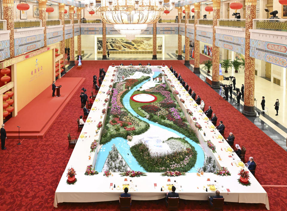 In this photo released by Xinhua News Agency, Chinese President Xi Jinping seen on podium and his wife Peng Liyuan host a banquet to welcome distinguished guests from around the world who attended the opening ceremony of the 2022 Winter Olympics at the Great Hall of the People in Beijing, China, Saturday, Feb. 5, 2022. Chinese President Xi Jinping declared the Winter Olympics open Friday night, inviting the world back — sort of — for the pandemic era's second Games, this time as an emboldened and more powerful nation whose government's authoritarian turn provoked some countries' leaders to stay home. (Shen Hong/Xinhua via AP)