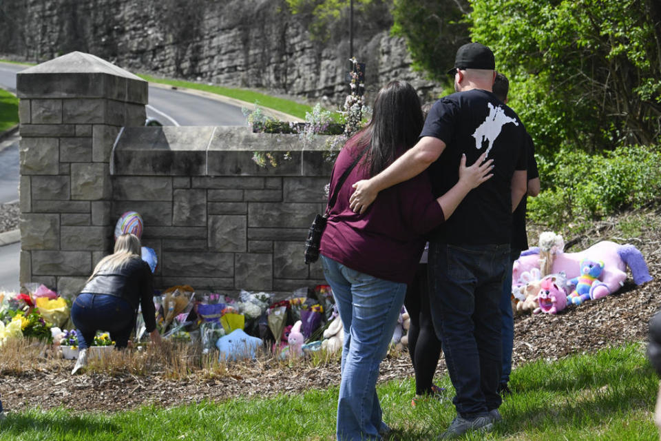 People gather at an entry to Covenant School, which has become a memorial for shooting victims on March 28, 2023, in Nashville, Tenn. / Credit: AP Photo/John Amis