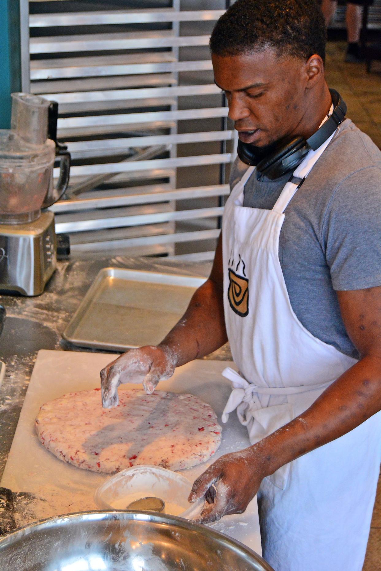 Scott Pass, owner of The Biscuit Center, has a batch of strawberry biscuit dough rolled out ready for cutting Wednesday at the temporary location of the Como Cooks business incubator kitchens on Walnut Street.