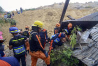 Rescuers conduct search houses for survivors after a landslide struck a village in Naga city, Cebu province central Philippines on Thursday Sept. 20, 2018. A landslide set off by heavy rains buried homes under part of a mountainside in the central Philippines on Thursday, and several people are feared buried, including two who sent text messages seeking help. (AP Photo)