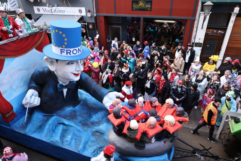 A Frontex and boat refugees float takes part in the Rose Monday parade. The Rhineland Street Carnival reaches its climax with the Rose Monday parade. The motto of the 2024 Cologne Carnival season is "Wat e Theater - wat e Jeckespill". Rolf Vennenbernd/dpa