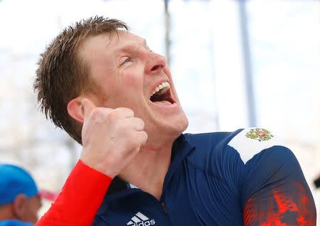 First placed Russia's pilot Alexander Zubkov celebrates after the four-man bobsleigh event of the Sochi 2014 Winter Olympic Games at the Sanki Sliding Center in Rosa Khutor in this file photo dated February 23, 2014. REUTERS/Arnd Wiegmann