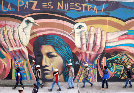 Indigenous Colombians rally for an imminent resolution to the nation’s peace agreement during a march with white flowers in Bogota, Colombia, October 12, 2016. REUTERS/John Vizcaino