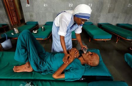 A nun belonging to the global Missionaries of Charity tends to a patient at Nirmal Hriday, a home for the destitute and old, founded by Mother Teresa ahead of Mother Teresa's canonisation ceremony, in Kolkata, India, August 31, 2016. REUTERS/Rupak De Chowdhuri