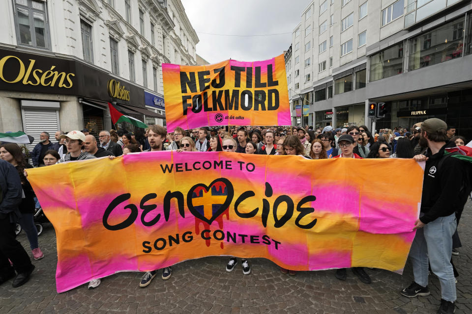 Protesters hold up a banner with the words in Swedish 