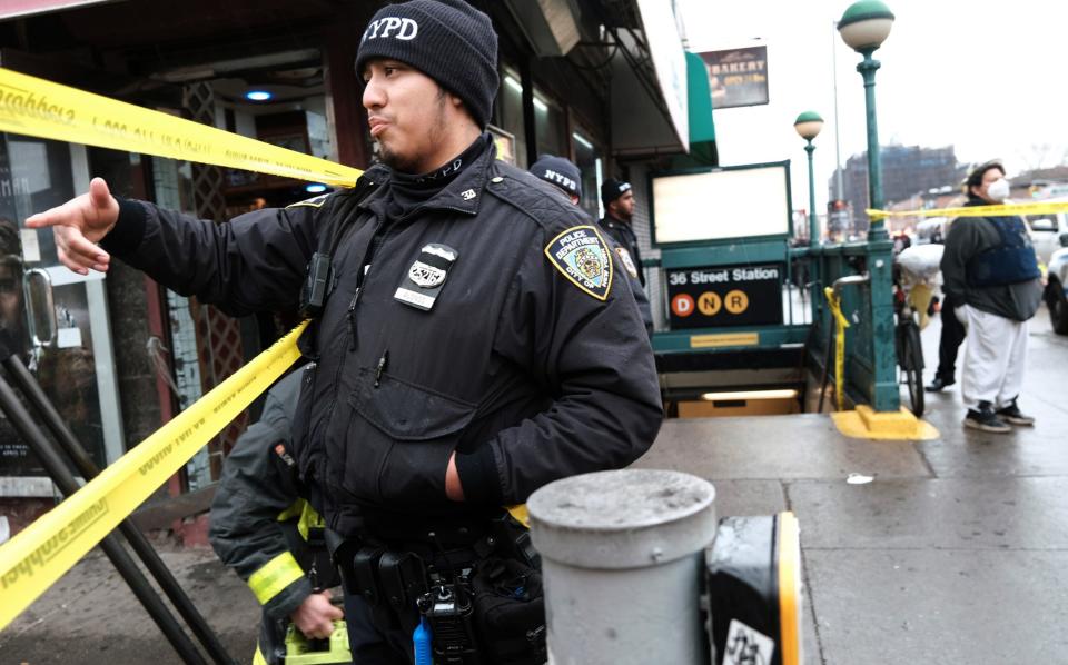 Police gather at the site of a reported shooting of multiple people outside of the 36 St subway station on April 12 - Getty Images/Spencer Platt 