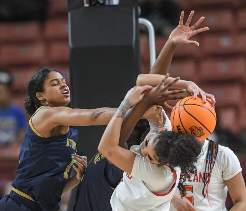 Notre Dame guard Cassandre Prosper (4) blocks a shot by Maryland guard Lavender Briggs (3) during the first quarter of the NCAA Women's Basketball Tournament at Bon Secours Wellness Arena in Greenville, S.C. Saturday, March 25, 2023. 