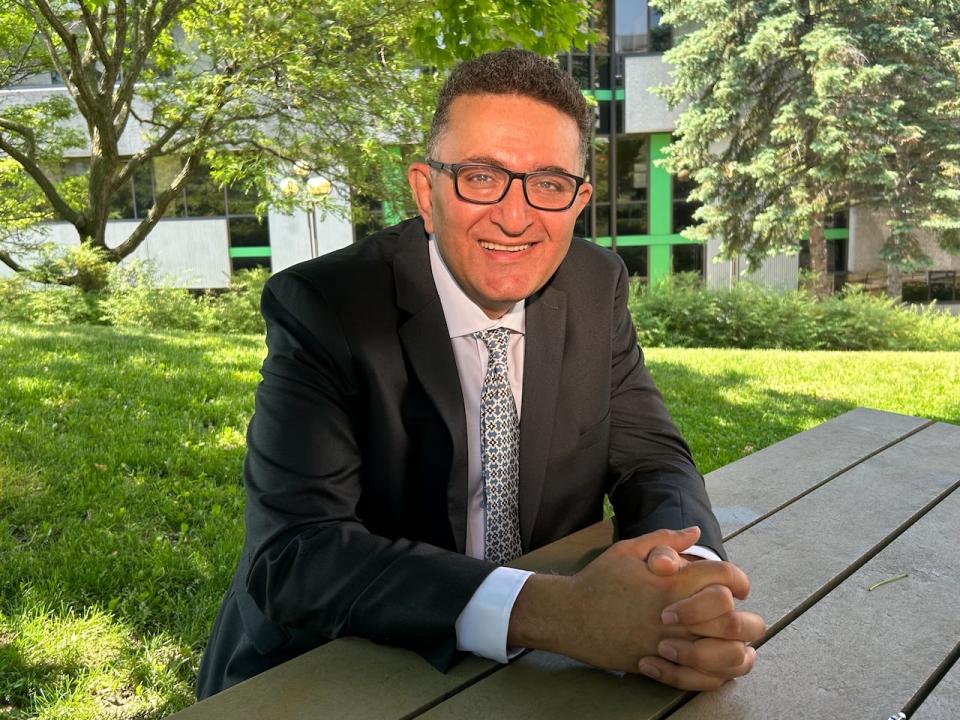 Doctor Ahmed Nasr sits at a table outside of CHEO on June 6, 2024. "We can save a lot of time for patient care," he said of AI technology.