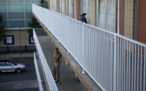 In this Oct. 12, 2018, photo, a bird is perched on a railing at a weekly rental motel in Reno, Nev. (AP Photo/John Locher)