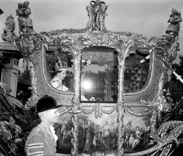 The Queen smiling in the Royal State Coach leaving Westminster Abbey for Buckingham Palace after the  coronation (PA)