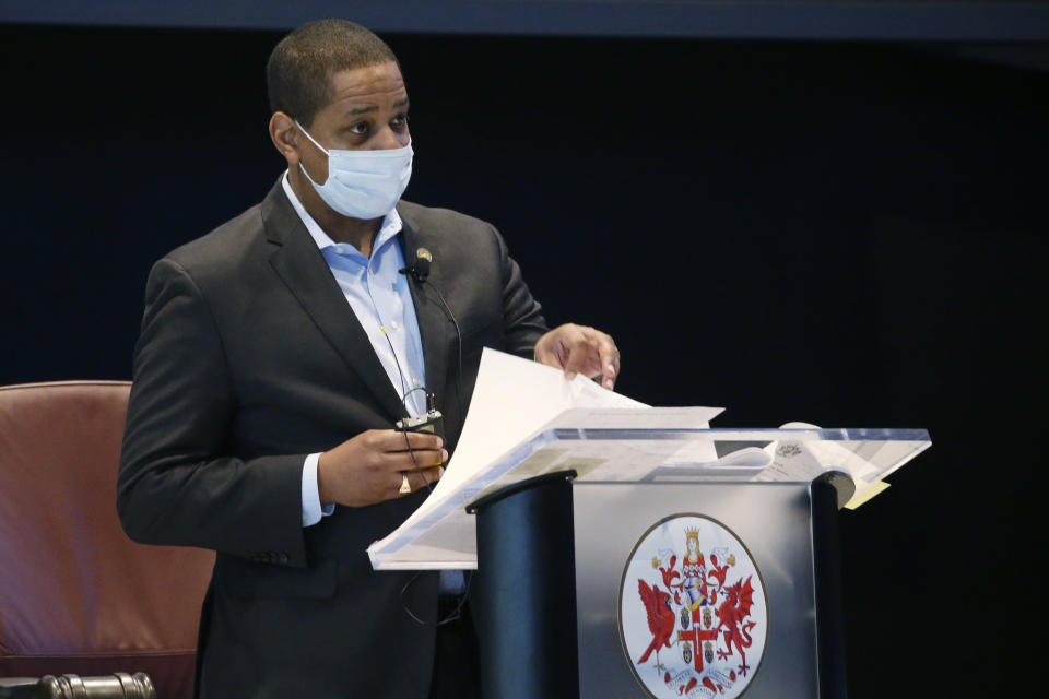 Virginia Lt. Gov. Justin Fairfax, breaks a tie vote on the Governors amendment delaying the implementation of the minimum wage during the reconvene session to order at the Science Museum of Virginia Wednesday April 22, 2020, in Richmond, Va. The Senate is meeting in a remote location due to COVID-19 social distancing restrictions. (AP Photo/Steve Helber, Pool)