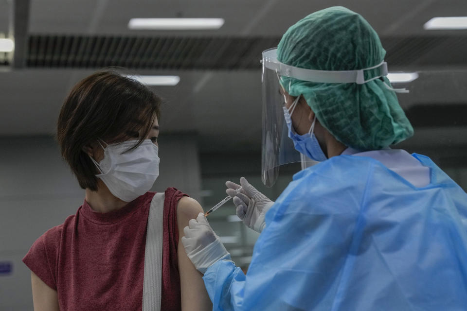 FILE - A health worker administers a dose of the Pfizer COVID-19 vaccine at the Central Vaccination Center in Bangkok, Thailand, Monday, Jan. 10, 2022. On Friday, Feb. 10, 2023, The Associated Press reported on stories circulating online incorrectly claiming Thailand is canceling its COVID-19 vaccine contract with Pfizer after its princess fell into a coma following a booster shot. (AP Photo/Sakchai Lalit, File)