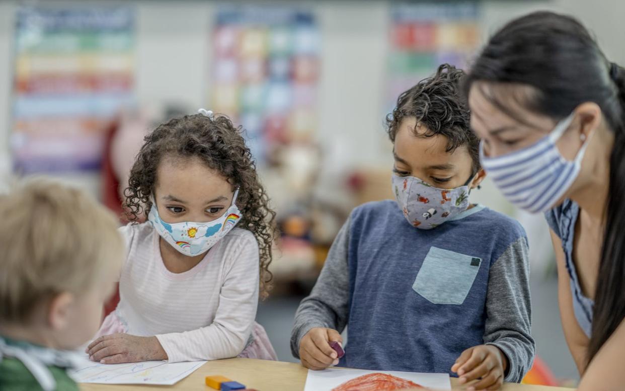 <span class="caption">High-quality day care has always been scarce in the U.S.</span> <span class="attribution"><a class="link " href="https://www.gettyimages.com/detail/photo/group-of-children-colouring-while-wearing-masks-royalty-free-image/1263061836" rel="nofollow noopener" target="_blank" data-ylk="slk:FatCamera/E+ via Getty Images;elm:context_link;itc:0;sec:content-canvas">FatCamera/E+ via Getty Images</a></span>