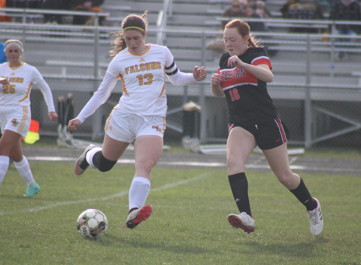 Cheboygan senior Penelope Balitz (16) and Ogemaw Heights' Adysen Kartes (13) battle for the ball during the first half of a girls soccer clash at Cheboygan on Friday.