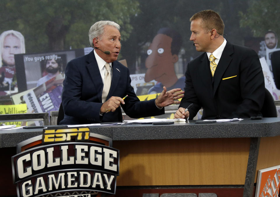 FILE - In this Oct. 11, 2014, file photo, ESPN College GameDay hosts Lee Corso, left, and Kirk Herbstreit confer during the telecast from The Junction prior to Mississippi State playing Auburn in an NCAA college football game in Starkville, Miss. This week the Cornhuskers are front and center. Their game against No. 5 Ohio State on Saturday night was always going to be a big one. Add a visit from ESPN’s “College GameDay” show in the morning, and it becomes huge. (AP Photo/Rogelio V. Solis, File)