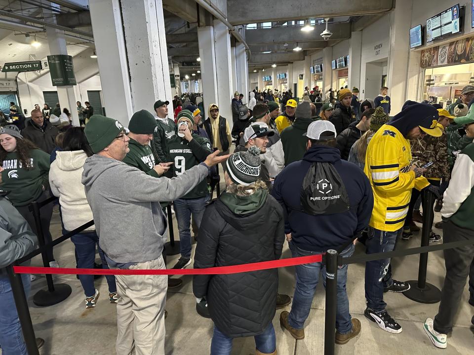 Fans line up to buy drinks at Spartan Stadium before the Michigan-Michigan State NCAA college football game Saturday, Oct. 21, 2023, in East Lansing, Mich. Michigan State University started selling alcoholic beverages at the stadium this fall. According to a survey by The Associated Press of Power Five conference schools and Notre Dame, 55 of 69 of them sell alcohol in the public areas of their stadiums on game days. (AP Photo/Mike Householder)