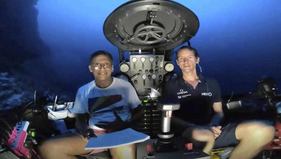 An image taken from video issued by Nekton shows Seychelles President Danny Faure, left, smiling after speaking from inside a submersible from the vessel Ocean Zephyr, under the water off the coast of Desroches, in the outer islands of Seychelles Sunday April 14, 2019. Faure toured the vessel and was presented with some of the findings and observations made by a British-led science expedition documenting changes taking place beneath the waves that could affect billions of people in the surrounding region over the coming decades (Nekton via AP)