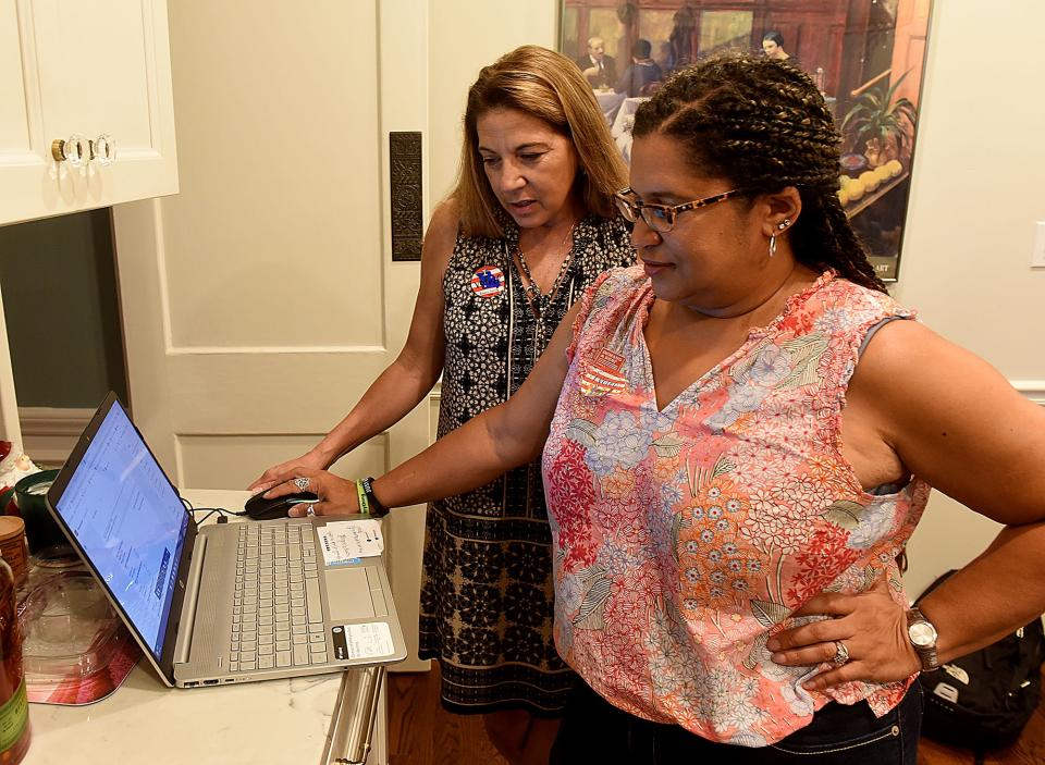 Chimene Schwach, Democratic candidate for state representative District 47, looks at early election results with her friend Tonya Ford on Tuesday during Schwach’s election watch party at her home. Schwach ran against Adrian Plank, who won with 2,325 votes to Schwach’s 2,277.
