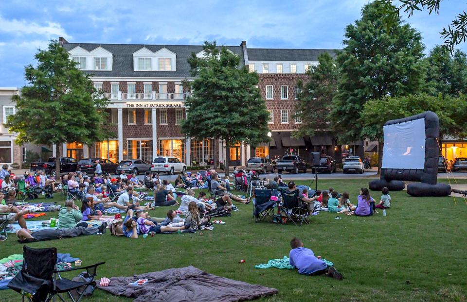 People watch "Wonka" projected on a inflatable screen in the park at Patrick Square, a Movies In May event presented by the Clemson Recreation Department in Clemson Friday, May 3, 2024.