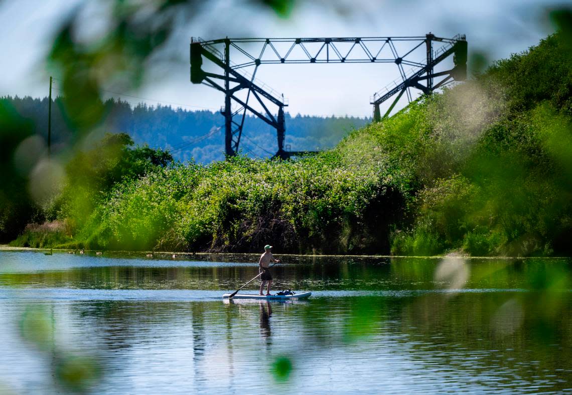A man paddle boards on Chambers Bay in Steilacoom, Wash. on Sunday, June 26, 2022. Temperatures climbed into the 90’s over the weekend in Tacoma.