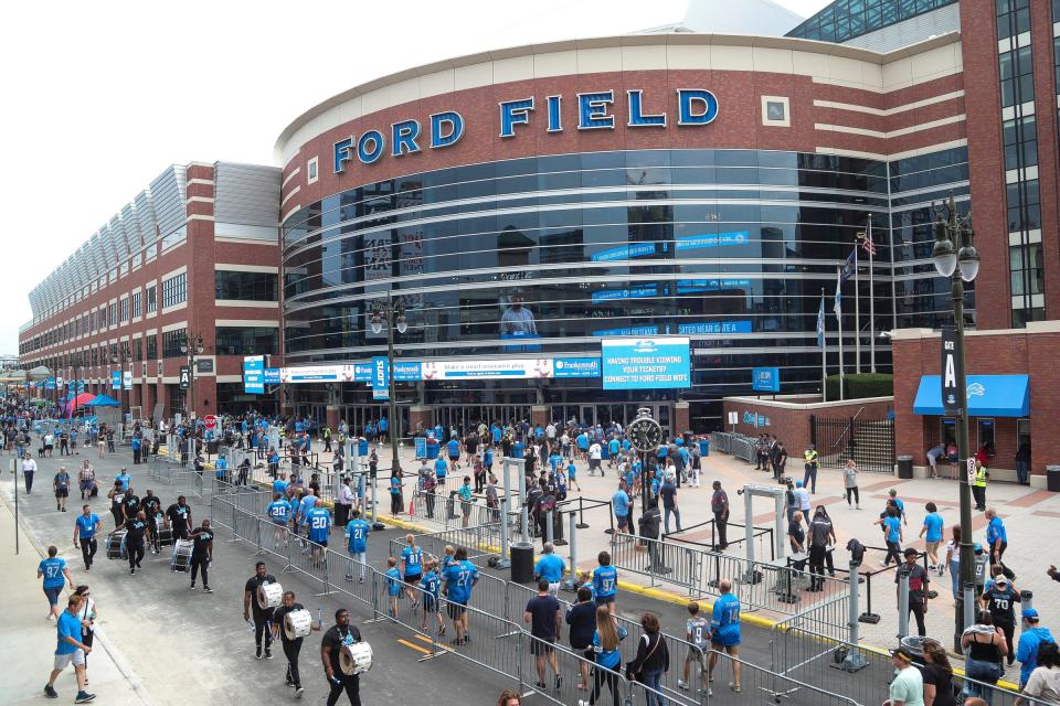 Football fans and the Lions drumlins enter Ford Field before a preseason game against the Giants at Ford Field on Friday, Aug. 11, 2023.
