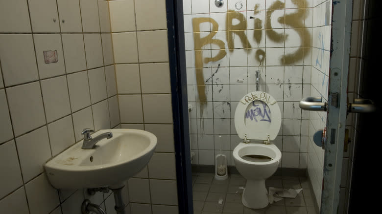 Dirty bathroom with graffiti 