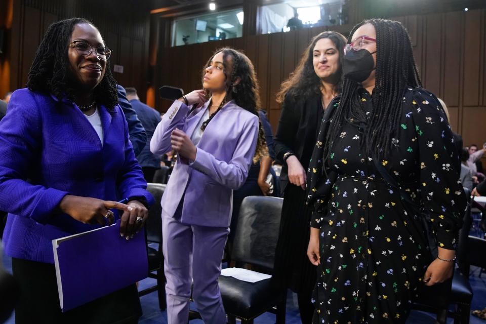 Supreme Court nominee Judge Ketanji Brown Jackson walks past her daughters, Leila, center, and Talia, during a break in her confirmation hearing before the Senate Judiciary Committee Monday, March 21, 2022, on Capitol Hill in Washington.