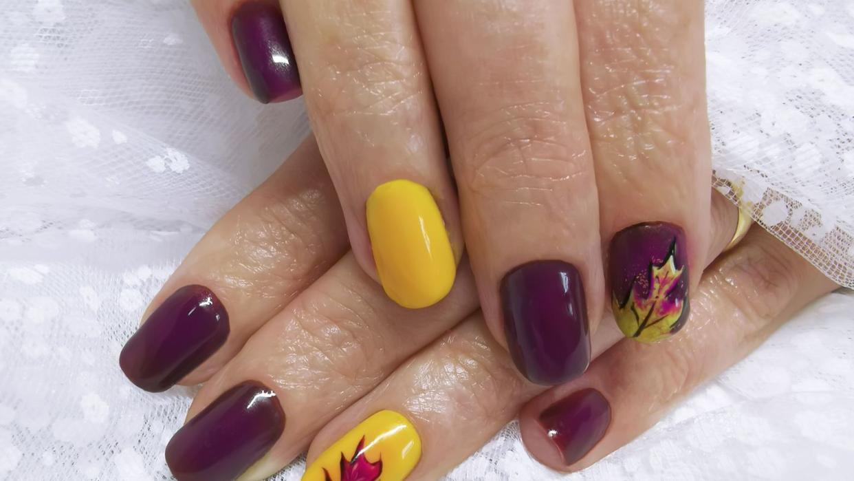 thanksgiving nails maroon and yellow fall leaves design