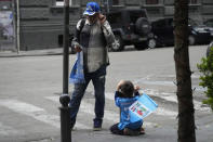 Napoli fans on the street in Naples during the Serie A soccer match between Napoli and Salernitana at the Diego Armando Maradona stadium, in Naples, Italy, Sunday, April 30, 2023. The game ended in a 1-1 draw and Napoli missed a chance to win the Italian title Sunday with six rounds left to play. (AP Photo/Gregorio Borgia)