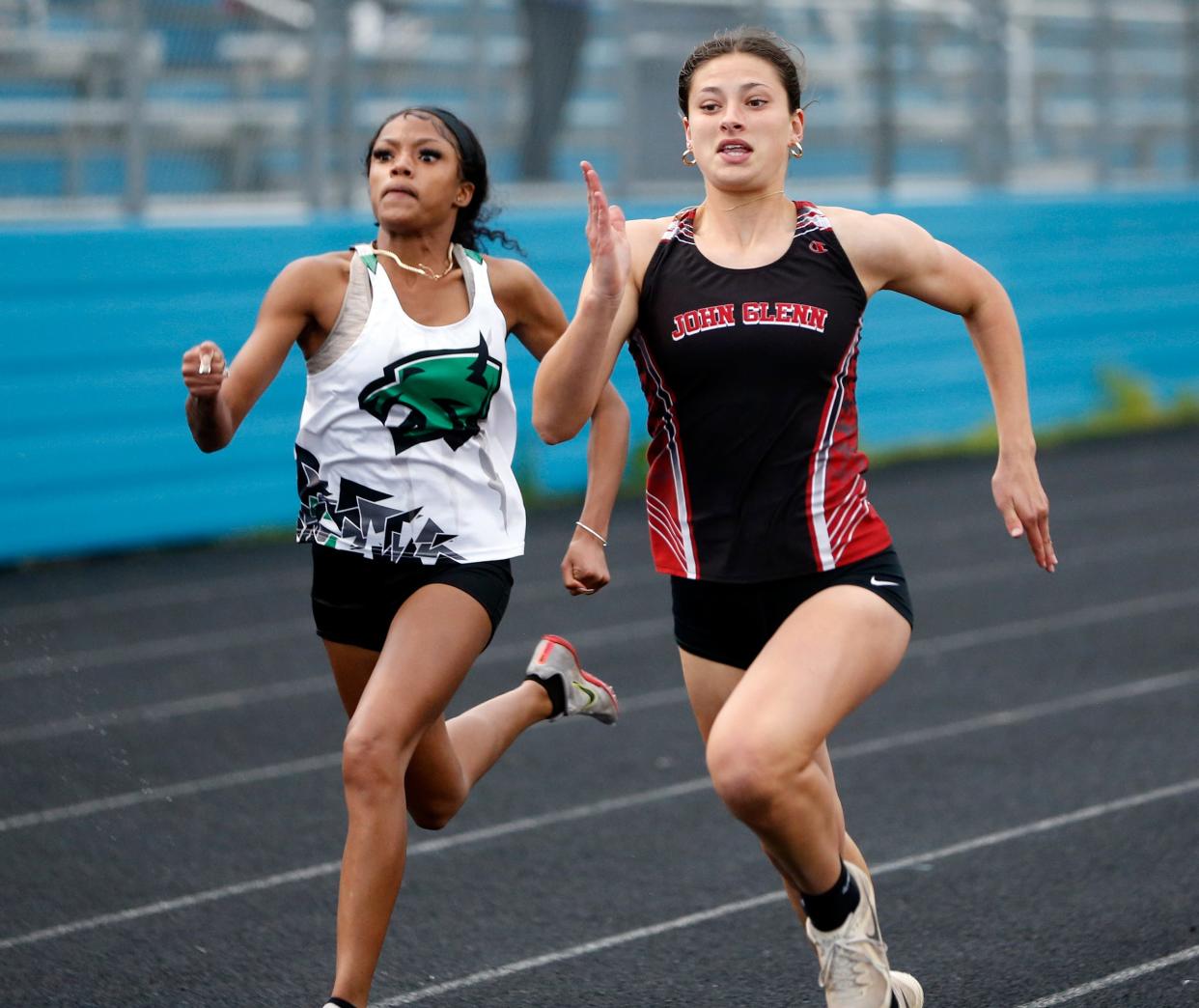 Glenn freshman Lydia Goodsell, right, and Washington senior Terryah Leonard sprint to the finish line in the 100-meter dash race at the girls track and field sectional Tuesday, May 14, 2024, at Saint Joseph High School in South Bend. Goodsell would win by 0.13 seconds.