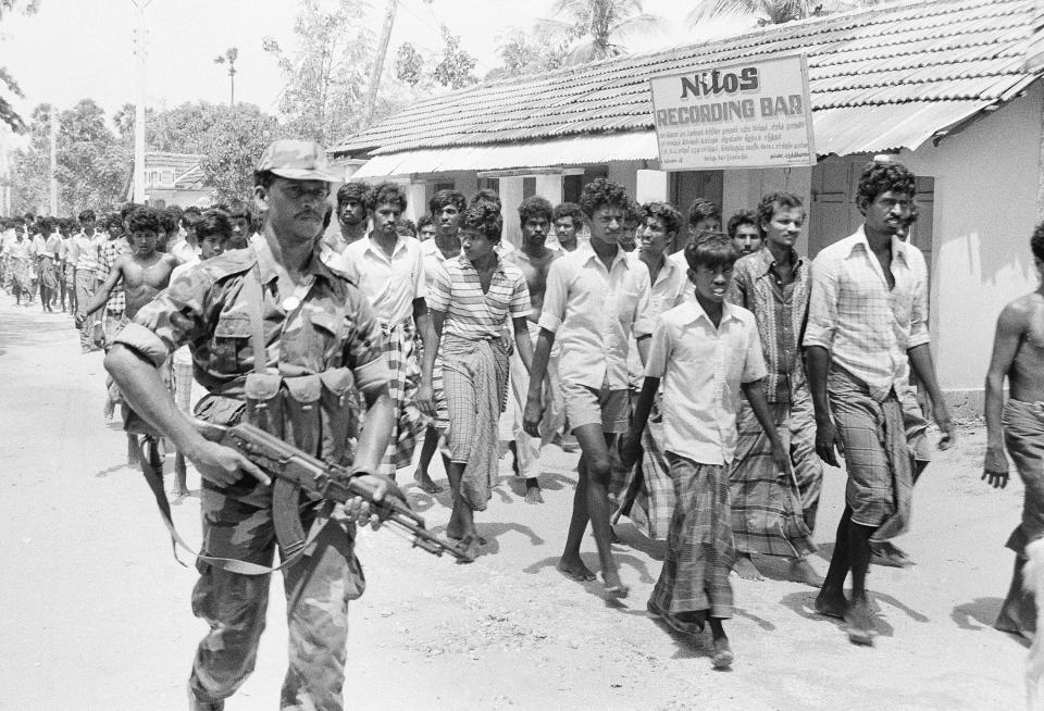 FILE- Sri Lankan troops detain Tamils to screen them for possible connections with militants at Nelliaddy village in the northern Jaffna Peninsula, Sri Lanka, June 2, 1987. (AP Photo/Dexter Cruez, File)