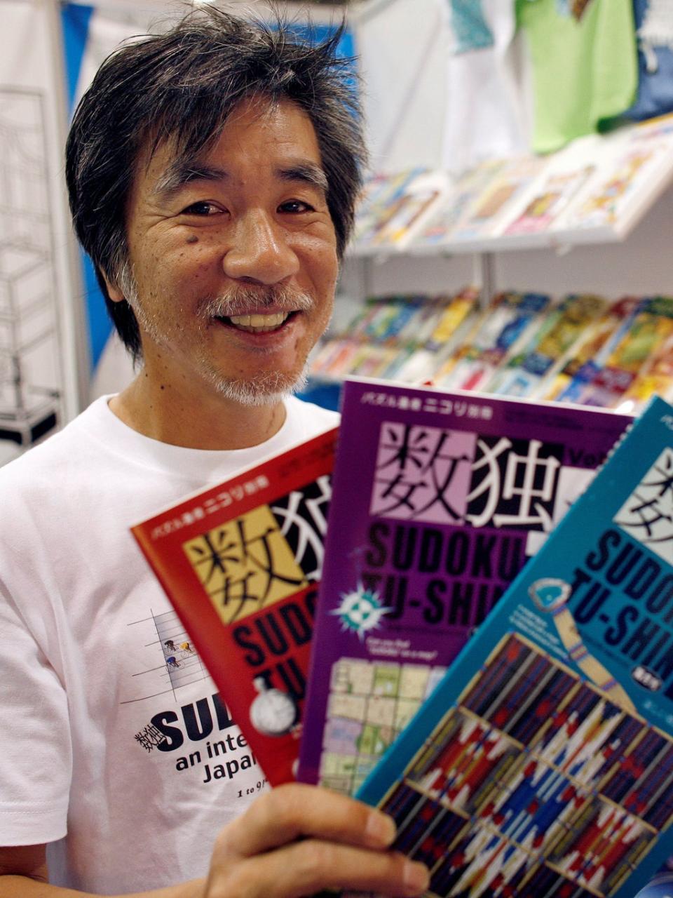 Kaji holds copies of the latest sudoku puzzles at the Book Expo, in New York, June 2007 (Reuters)