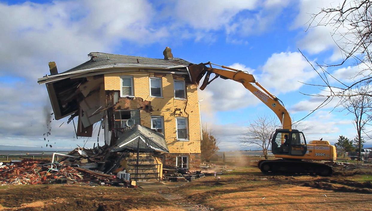 The house in Union Beach, which had become a symbol for all the devastation caused by Superstorm Sandy, is knocked down.