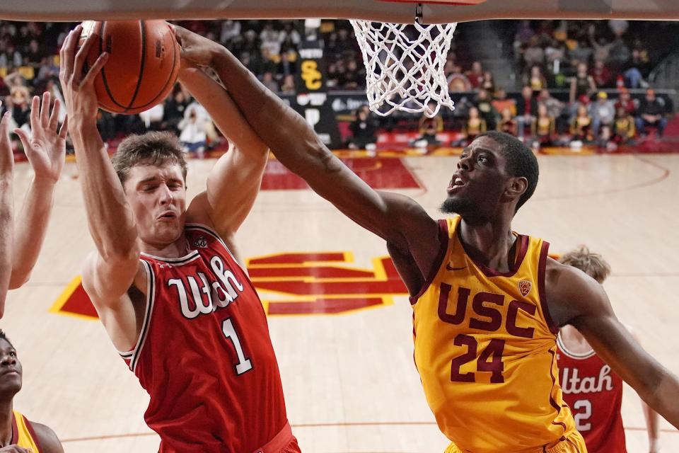 Utah forward Ben Carlson, left, grabs a rebound away from Southern California forward Joshua Morgan during the second half of an NCAA college basketball game Thursday, Feb. 15, 2024, in Los Angeles. | Mark J. Terrill, Associated Press