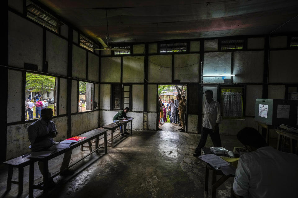 People arrive to cast their votes in a polling station during the third phase of general election in Guwahati, Assam, India, Tuesday, May 7, 2024. (AP Photo/Anupam Nath)