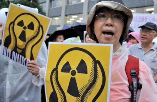 People shout slogans during a demonstration denouncing nuclear power plants, on July 20. Thousands of people are expected to form a "human chain" around Japan's parliament on Sunday as part of demonstrations aimed at ending nuclear power after last year's atomic crisis at Fukushima