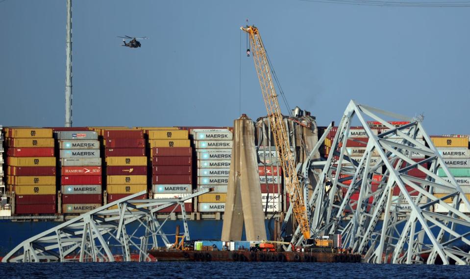 A crane works on clearing debris from the Francis Scott Key Bridge (Getty Images)