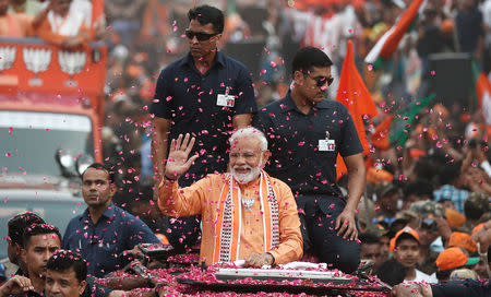 India's Prime Minister Narendra Modi waves towards his supporters during a roadshow in Varanasi, India, April 25, 2019. REUTERS/Adnan Abidi