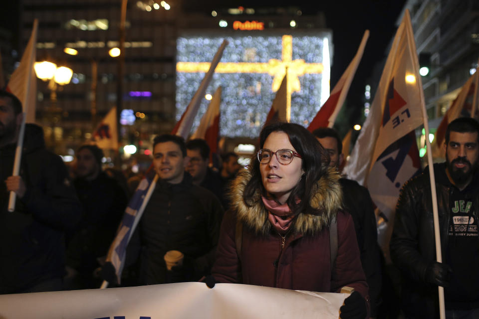 Members of the Communist-affiliated PAME labor union hold flags during a protest in central Athens on Tuesday, Dec. 18, 2018, as the Greek lawmakers are debating the heavily-indebted country's draft budget for 2019, the first since Greece exited an eight-year bailout program. (AP Photo/Petros Giannakouris)