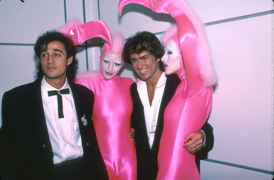 Singers Andrew Ridgeley (L) and George Michael (2R) of pop group Wham! with pink flamingo creatures.  (Photo by Time Life Pictures/DMI/The LIFE Picture Collection via Getty Images)