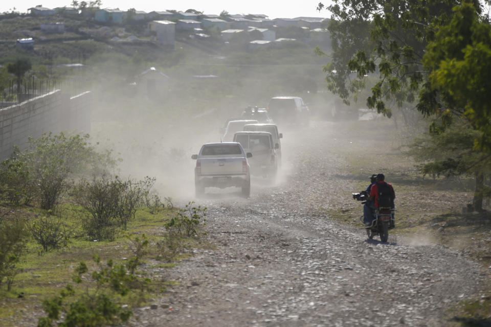 FILE - A caravan drives to the airport after departing from the Christian Aid Ministries headquarters at Titanyen, north of Port-au-Prince, Haiti, Dec. 16, 2021. A year after 17 North American missionaries were kidnapped in Haiti, beginning a two-month ordeal before they ultimately went free, Christian Aid Ministries, the agency that sent them hasn't made a permanent return, and several other international groups have also scaled back their work there. (AP Photo/Odelyn Joseph, File)