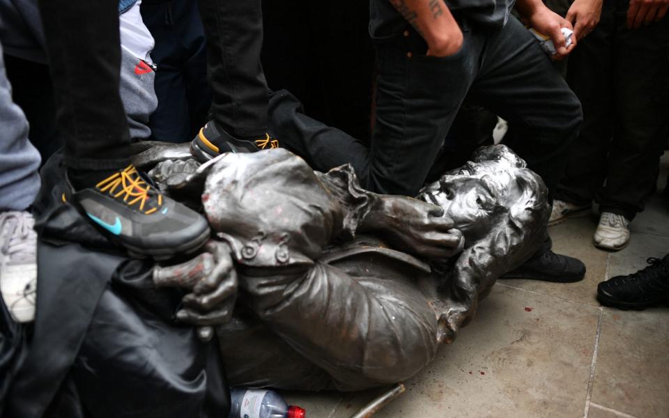 Protesters kneel on neck of Edward Colston statue - PA