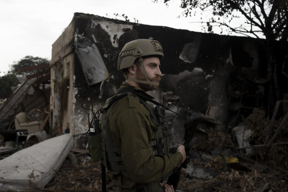 An Israeli soldier stands guard during a visit by former New Jersey Governor Chris Christie to Kibbutz Kfar Azza, near the Israel-Gaza border, the site of an Oct. 7 massacre by Hamas, Sunday, Nov. 12, 2023. (AP Photo/Maya Alleruzzo)