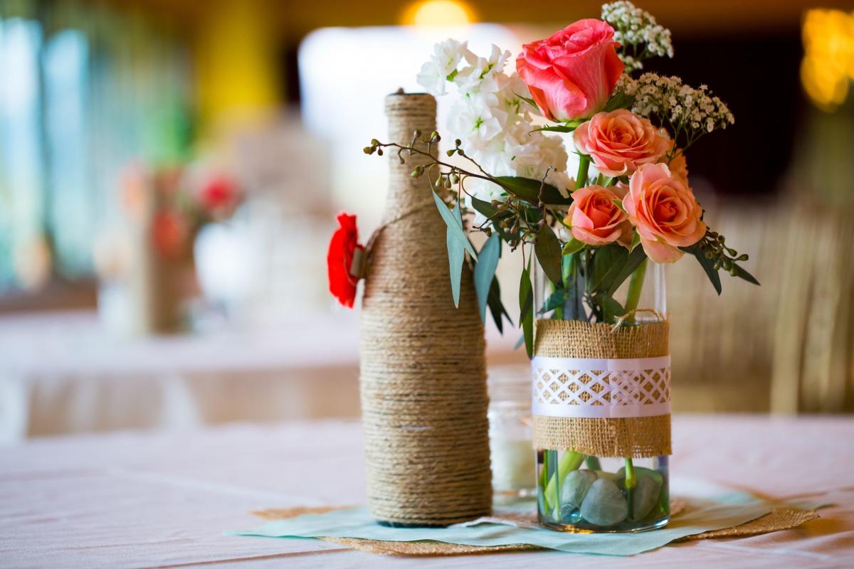 Succulents, rocks, pine cones, flowers in wood boxes for centerpieces
