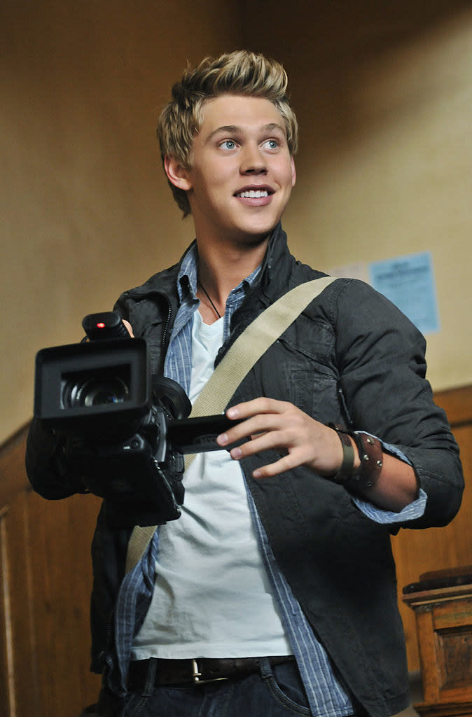 Close-up of Austin holding a large camera